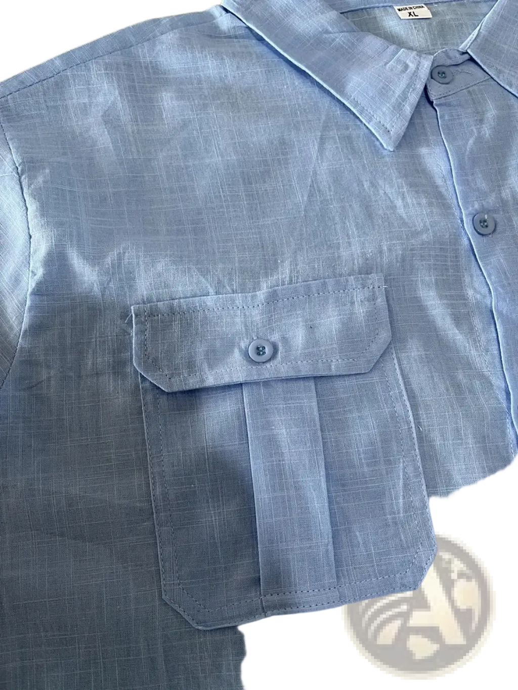 Light blue linen short sleeve shirt with subtle grid pattern and chest pocket for casual summer wear