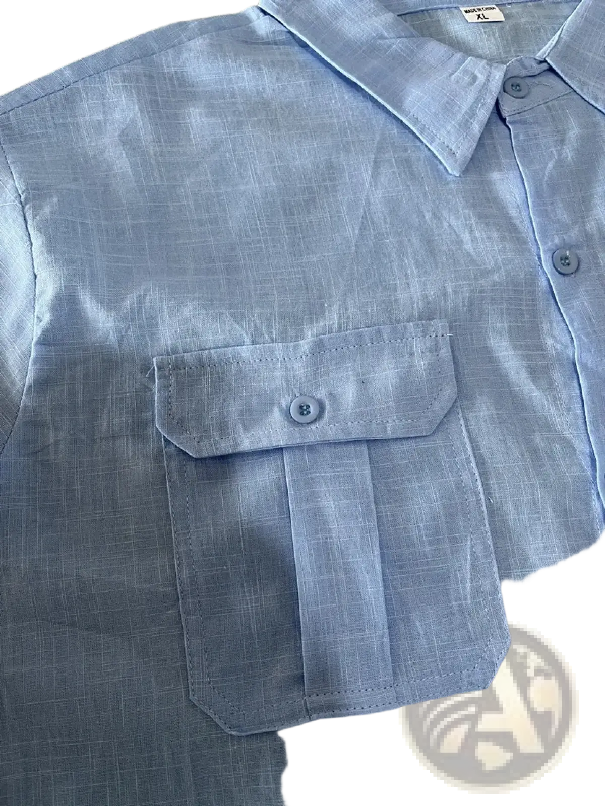 Light blue linen short sleeve shirt with subtle grid pattern and chest pocket for casual summer wear