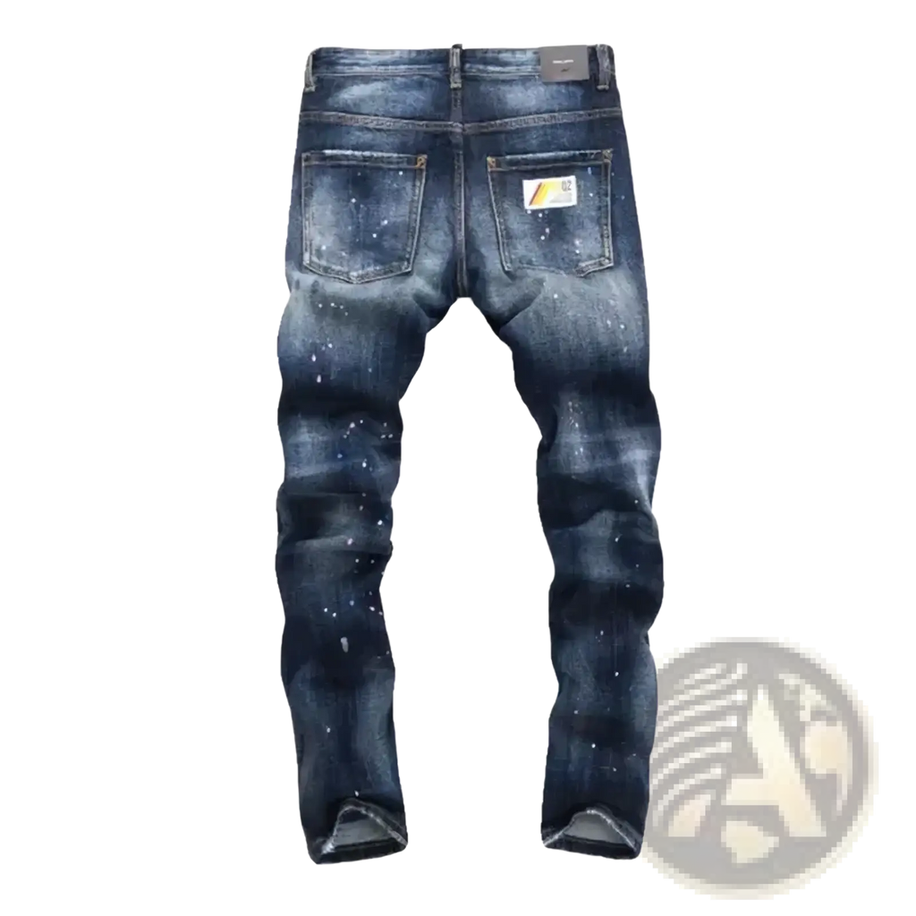 Back side of men paint splatter straight denim jeans in dark blue distressed denim with white paint splatter and yellow black label