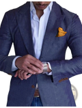 A sleek silver-toned watch with a polished metal band worn on the wrist paired with a men plaid blazer slim fit british style jacket