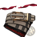 A men’s plaid leather belt in black and beige with a gold-toned automatic buckle displayed in a gift box