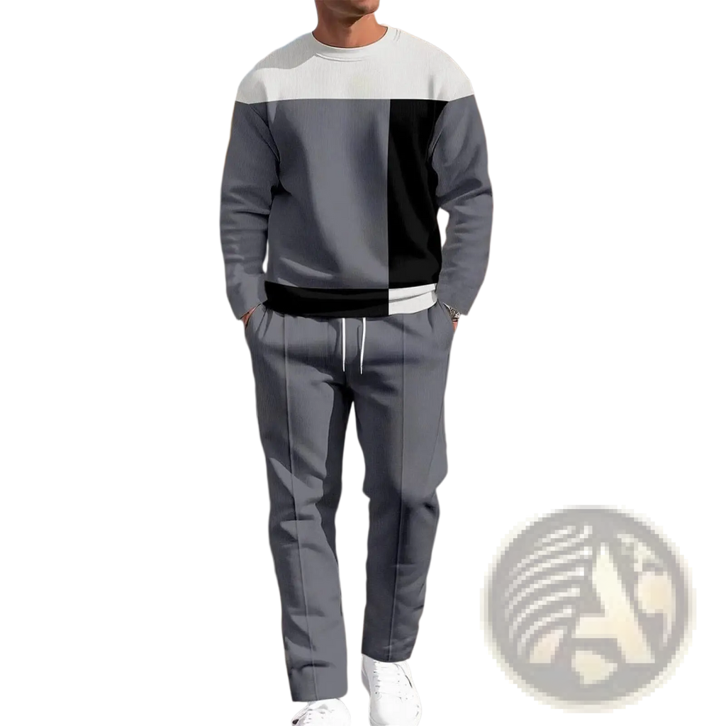 A man wearing a gray, black, and white color-blocked men plaid sweatshirt and matching jogger pants set