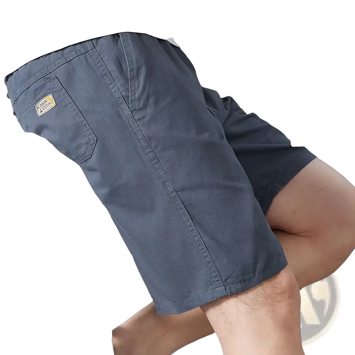 Back side of men pure cotton casual loose summer shorts in dark gray with a small yellow and black brand patch on pocket