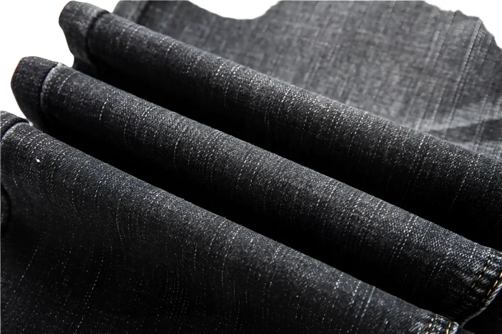 Men regular fit stretch denim jeans in dark wash with textured fabric and visible stitching on rolled cuffs