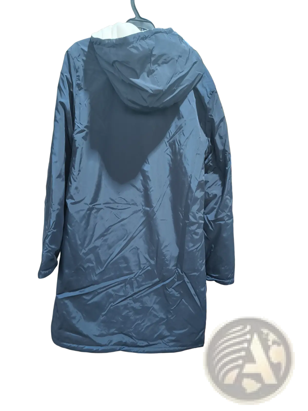 Men reversible shearling winter hooded coat shown as dark blue quilted puffer jacket with hood hanging on rack
