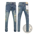 Men ripped skinny jeans in blue denim with distressed retro wash, paint splatters, and torn details