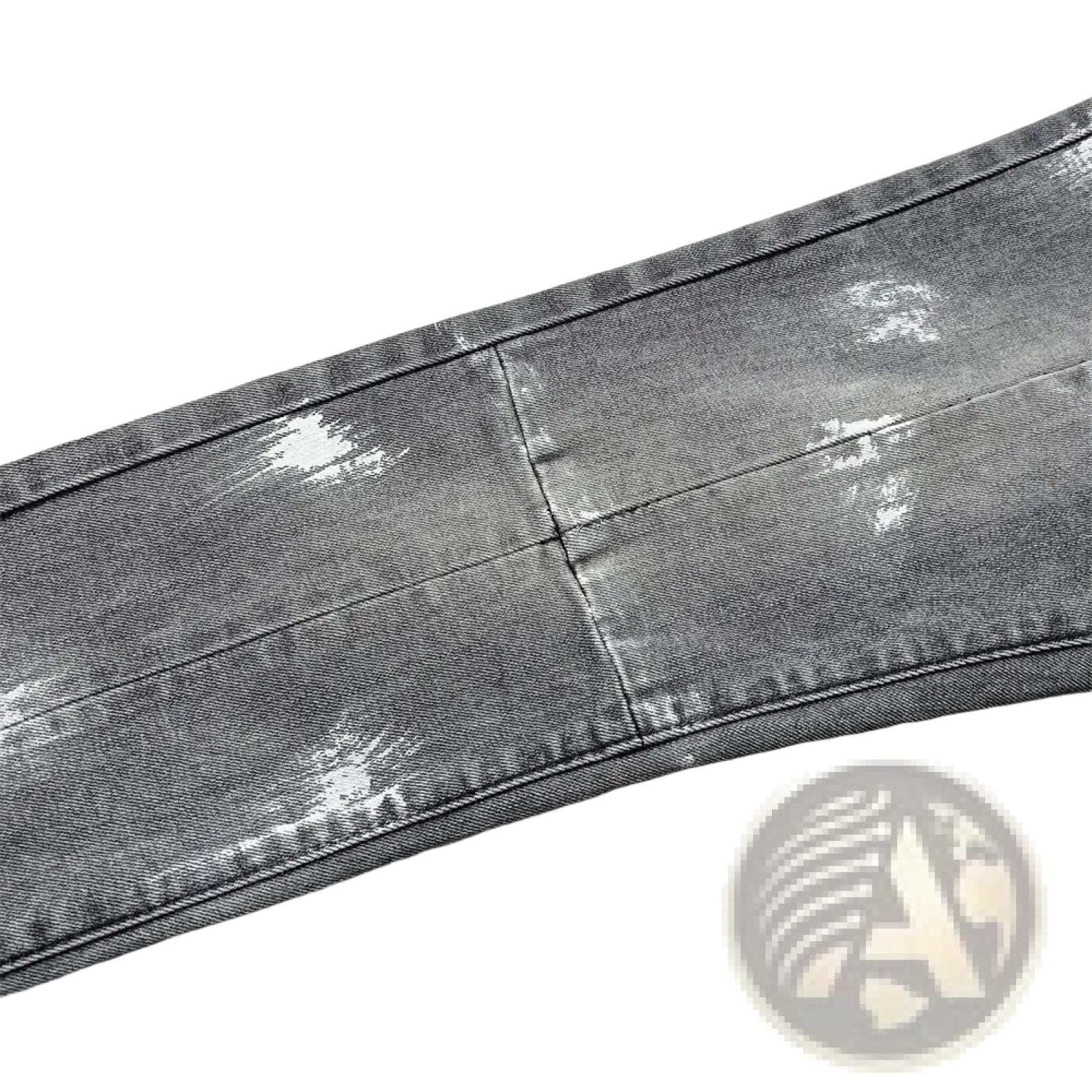 Men ripped skinny jeans in distressed gray denim with faded wash and subtle white paint splatter accents