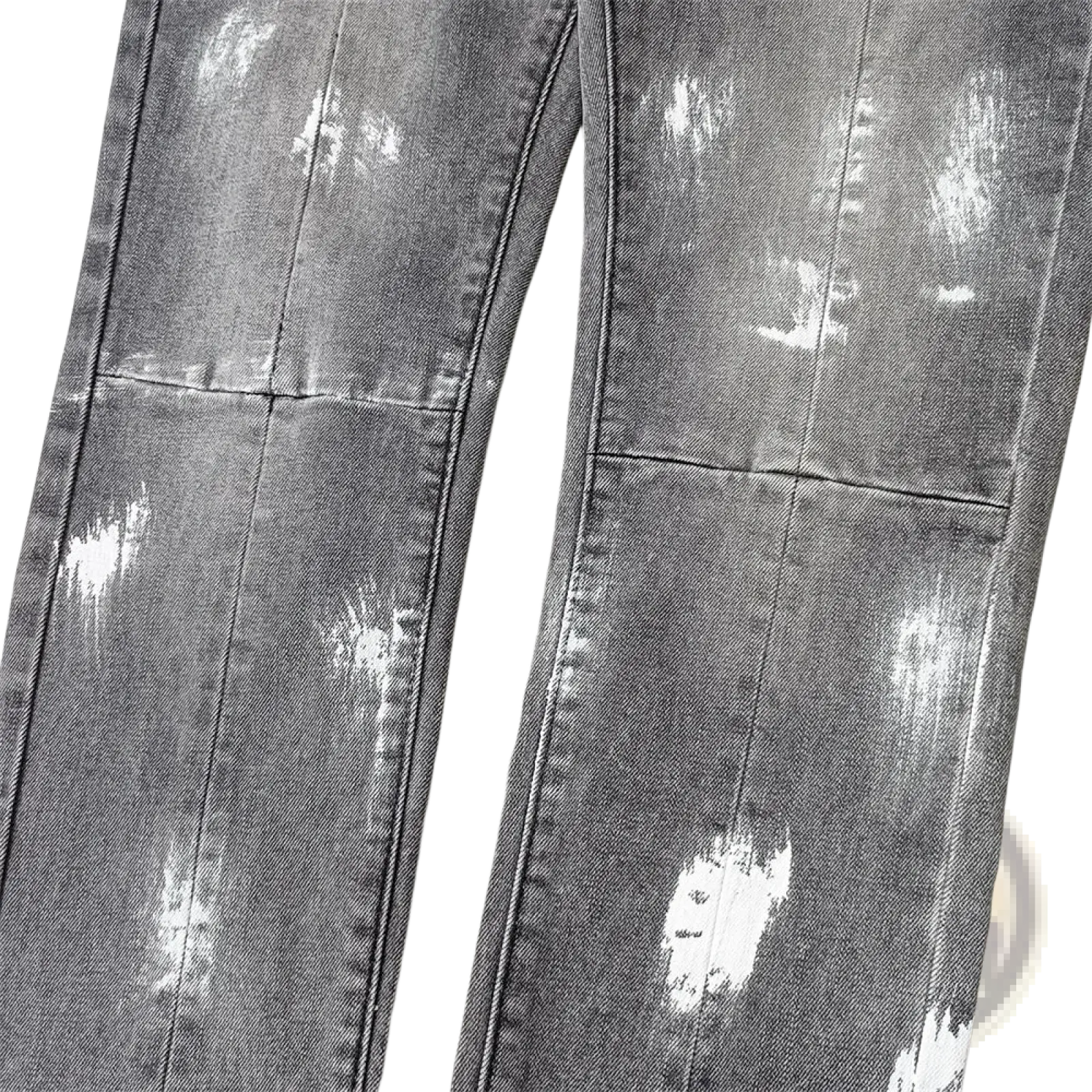 Men ripped skinny jeans in distressed gray denim with white paint splatter effects and retro wash blue tones