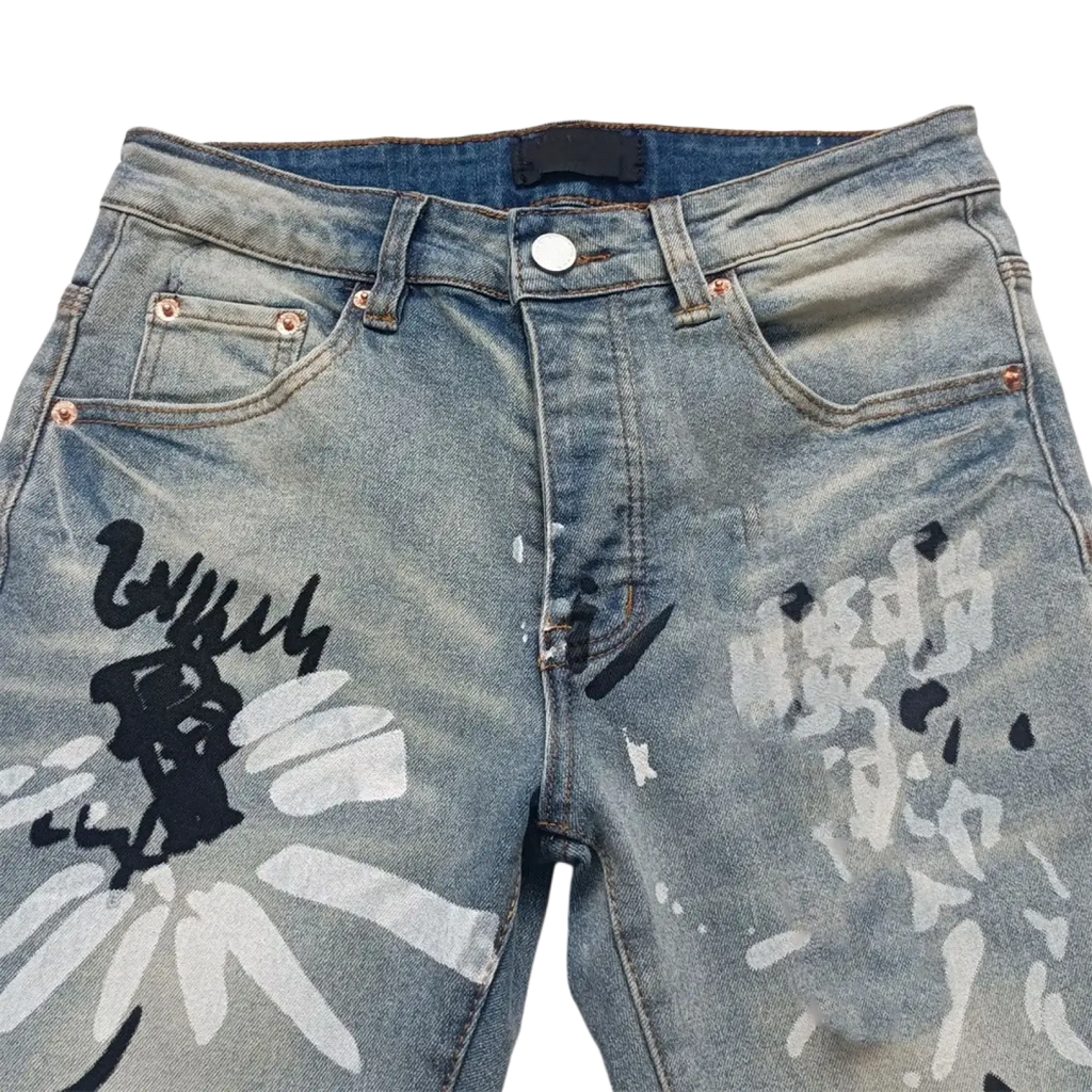 Men ripped skinny jeans in light-wash denim with bold black and white graffiti-style floral designs and distressed retro wash