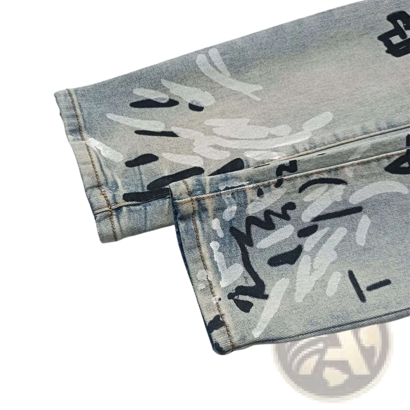 Men ripped skinny jeans in light-wash denim with bold black and white graffiti-style lettering and distressed detailing