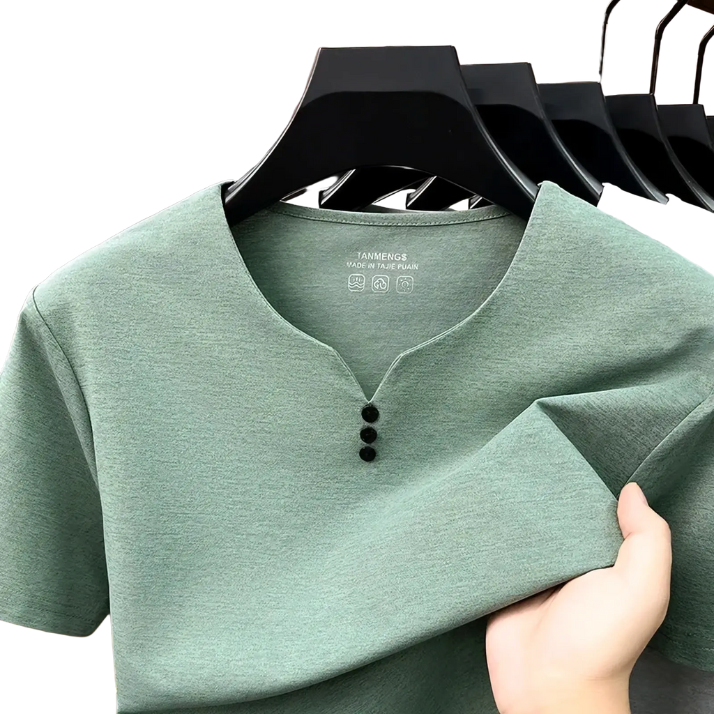 Men short sleeve henley shirt in soft sage green with three black buttons and subtle textured fabric on black hanger