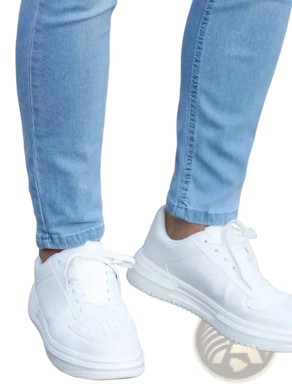 White platform sneakers with a minimalist design and perforated toe box paired with men slim fit dark blue denim jeans