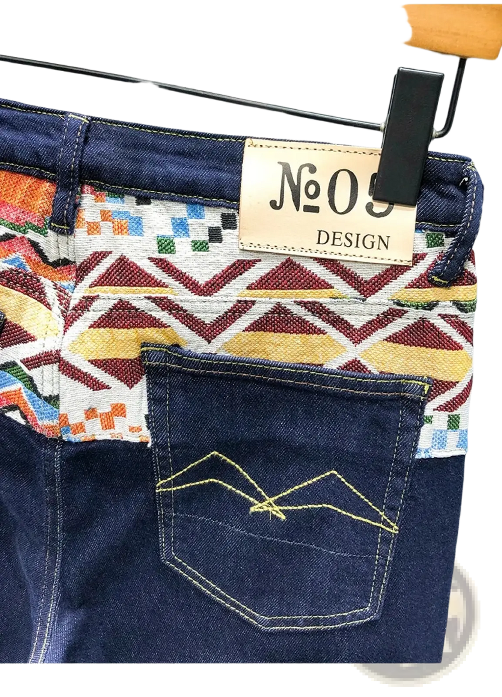 Blue denim men slim fit stretch embroidered jeans back side with colorful geometric waistband and yellow mountain stitching
