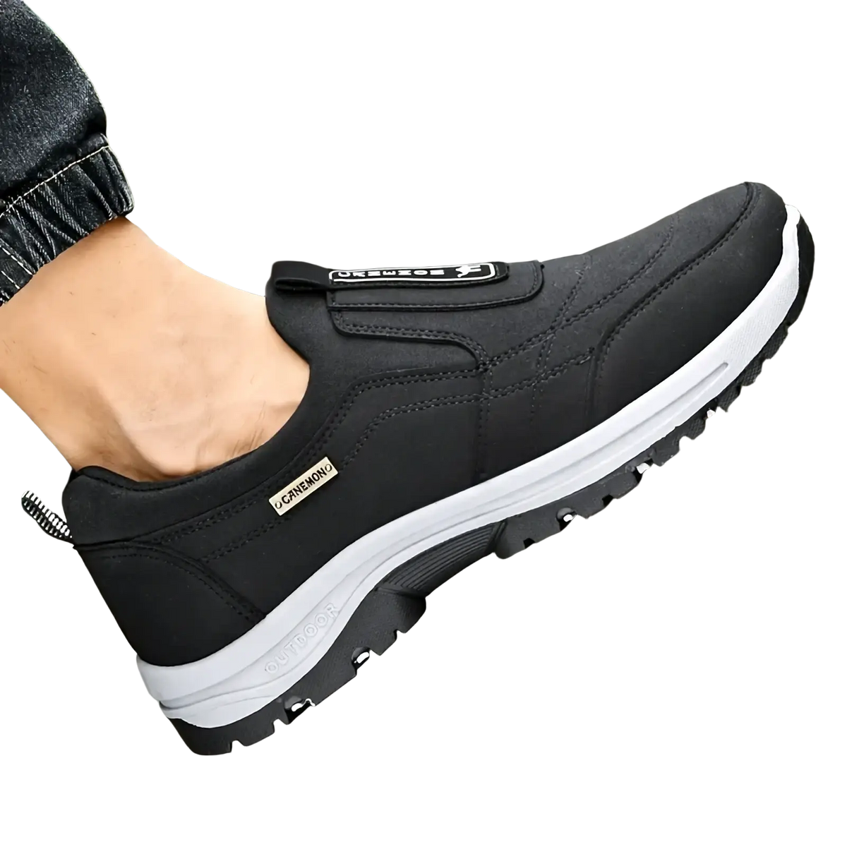 Men slip resistant casual walking sneakers in black with white midsole, velcro strap, and textured rubber outsole