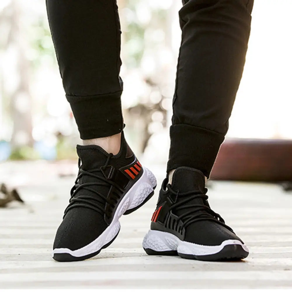 Men’s breathable mesh athletic sports sneakers in black with red stripes and white soles for enhanced comfort