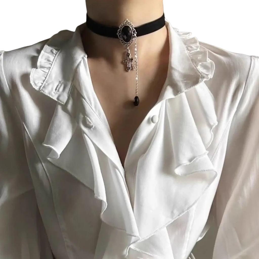 Black velvet choker necklace with silver ornate clasp and black gemstone cross pendant paired with men’s casual shirt and trousers