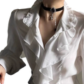 Black velvet choker necklace with silver ornate pendant and crystal chain paired with men solid color casual shirt and trousers