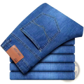 Men straight leg stretch denim jeans in blue with a brown leather brand tag on the waistband back side view