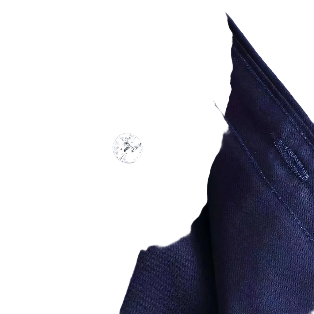 A round silver-toned button with textured pattern on the dark navy collar of a men stretch dress shirt anti-wrinkle long sleeve