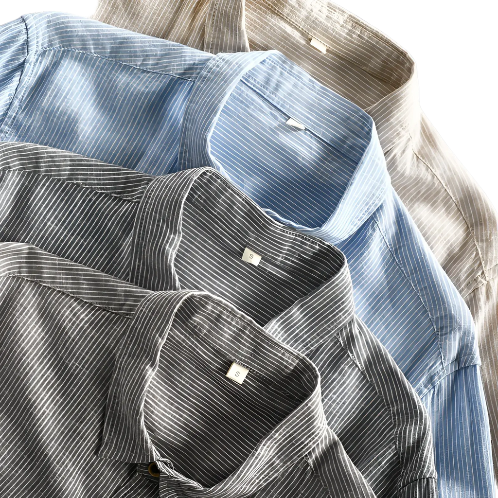 A stack of neatly folded men striped linen long sleeve shirts in soft blue and gray tones with subtle vertical stripes