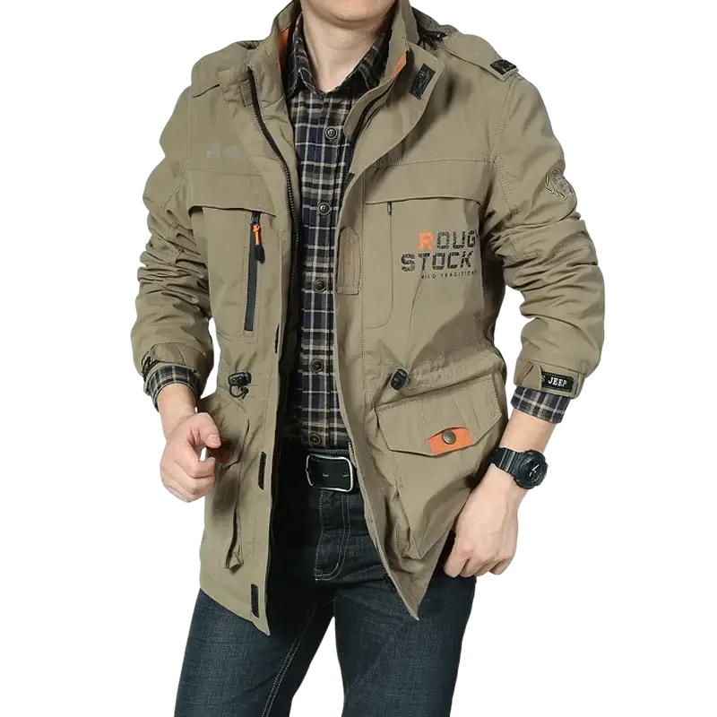 Men tactical waterproof outdoor jacket in khaki olive green with multiple pockets and orange zipper pulls featuring roug stock logo