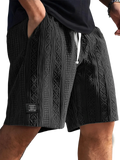 Men textured casual shorts in black with a woven pattern and white drawstrings for everyday wear