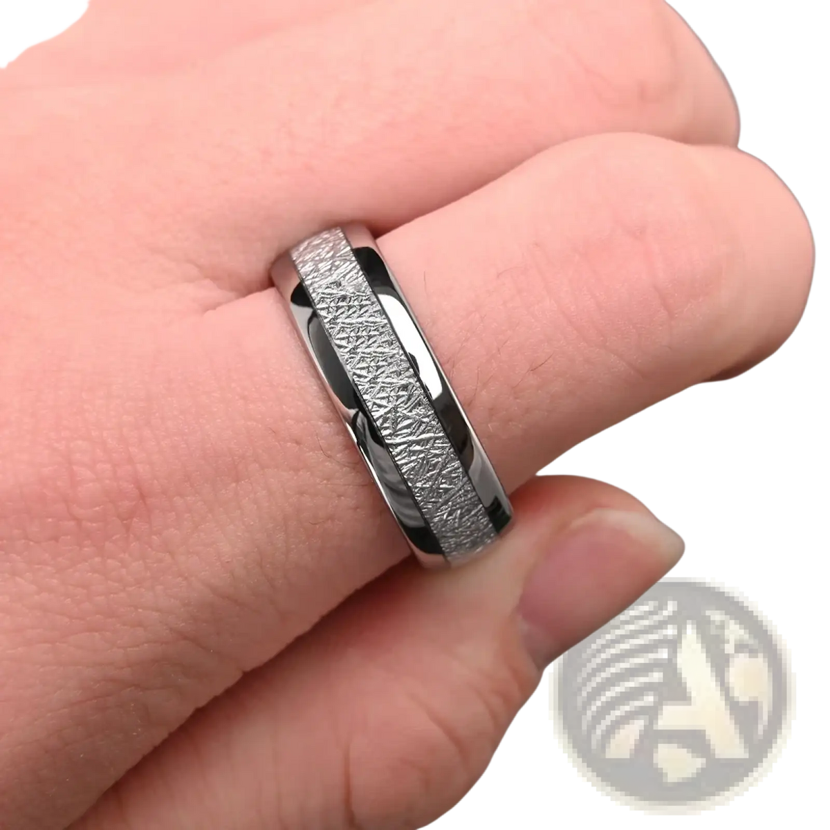 A sleek silver-toned men tungsten wedding band with a textured meteorite inlay and polished metallic edges
