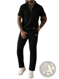 Men two piece zip polo outfit featuring a black textured polo shirt with zipper collar and black trousers with brown leather patches
