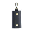 Dark navy leather men’s minimalist wallet and key organizer case with gold snap buttons and silver carabiner clip