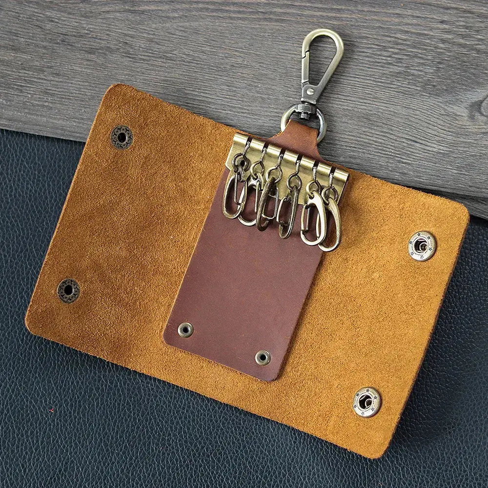Men’s minimalist leather wallet and key organizer case in tan with brown inner panel and five silver metal rings on carabiner clip