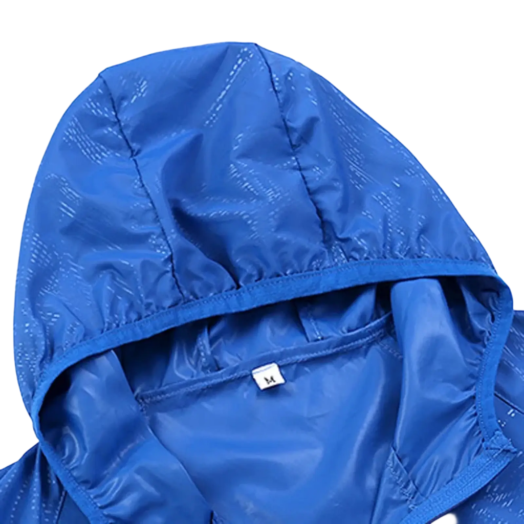Men waterproof hiking jacket windbreaker outdoor coat in bright blue lightweight nylon with stitched seams and textured hood