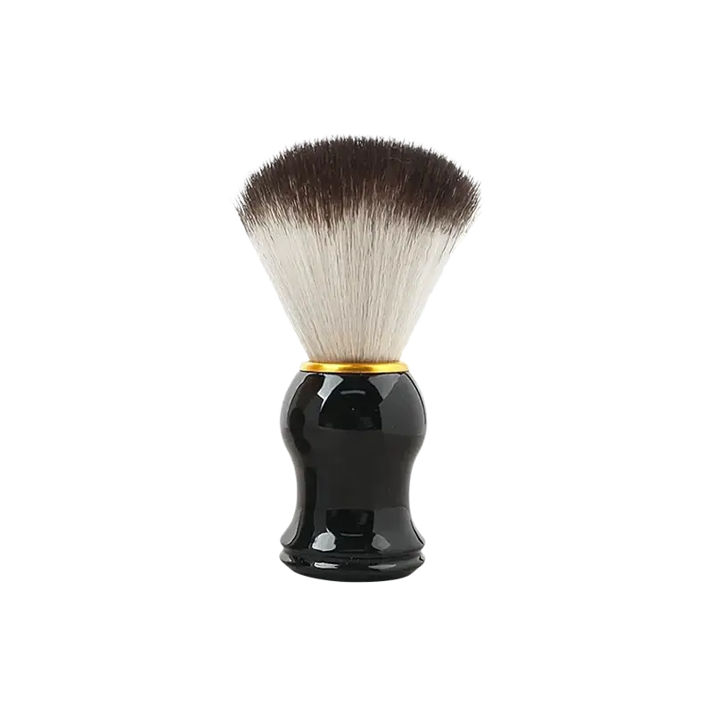 Men wet shaving kit with black glossy handle shaving brush with gold trim and two-toned dense bristle head next to shaving bowl