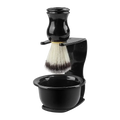 Black shaving brush with white and dark bristles mounted on black stand with integrated shaving bowl for wet shaving kit