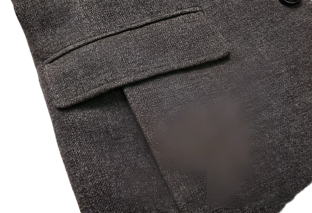 Men wool overcoat in textured charcoal gray wool with subtle herringbone weave and stitched flap pocket for winter wear