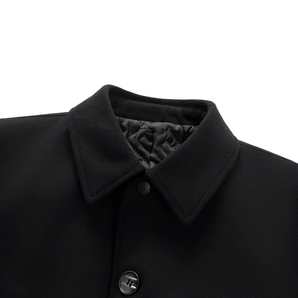 Black woolen overcoat for men with structured collar and subtle quilted lining for added warmth and style