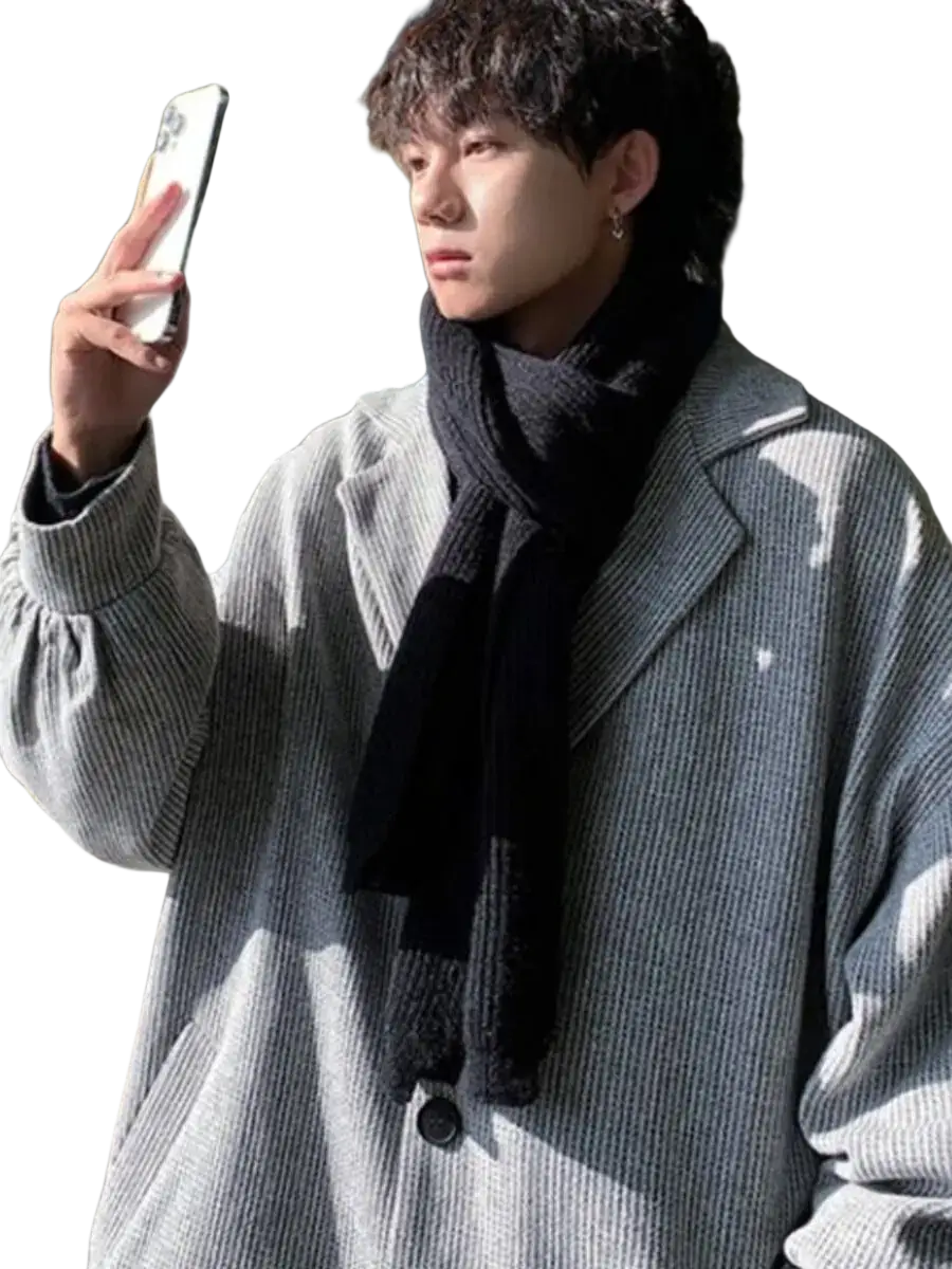 Men woolen overcoat in gray corduroy with black scarf showcasing a relaxed fit outerwear style