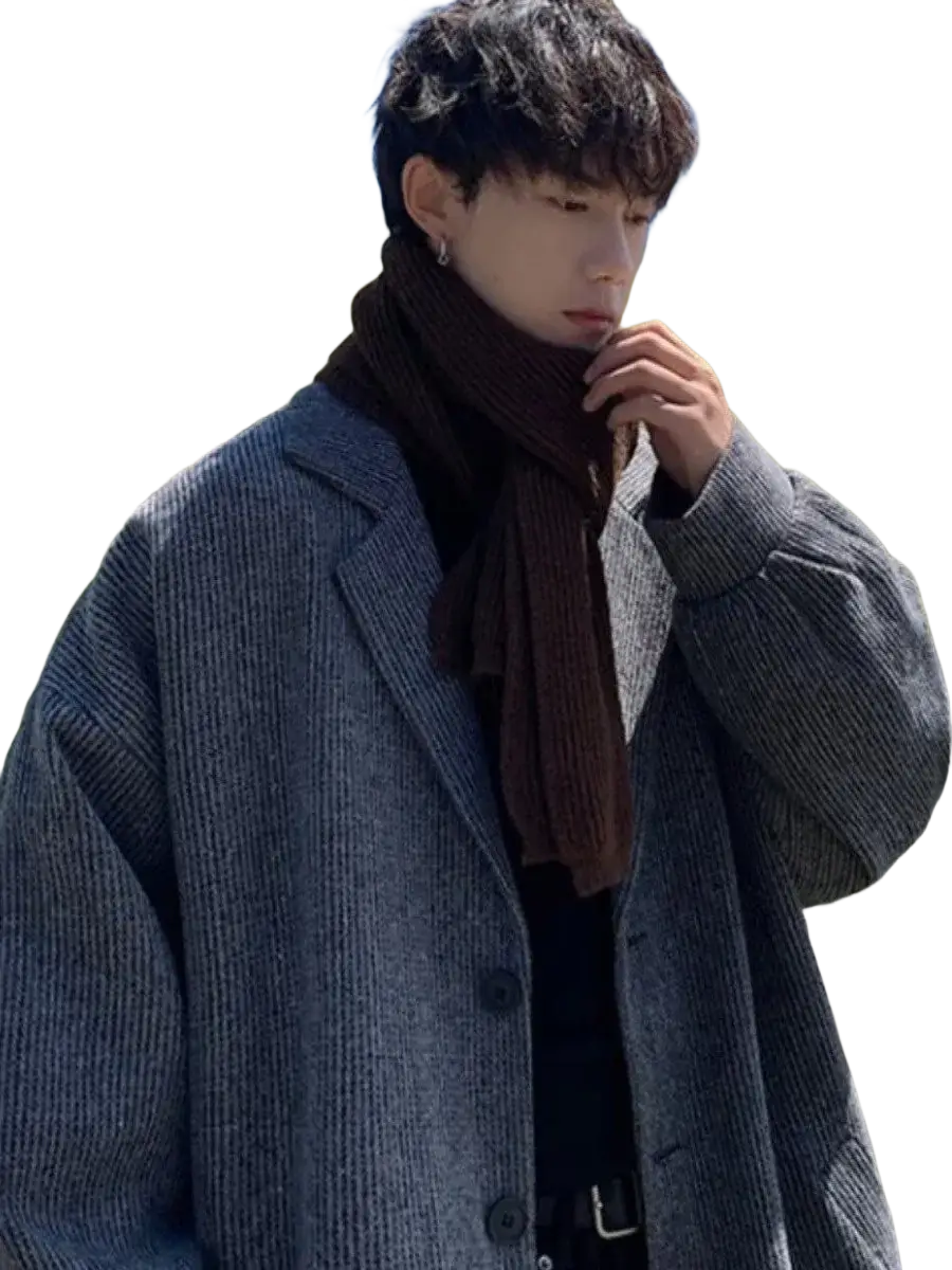 Gray ribbed wool men overcoat with relaxed fit paired with a dark brown knitted scarf for stylish outerwear