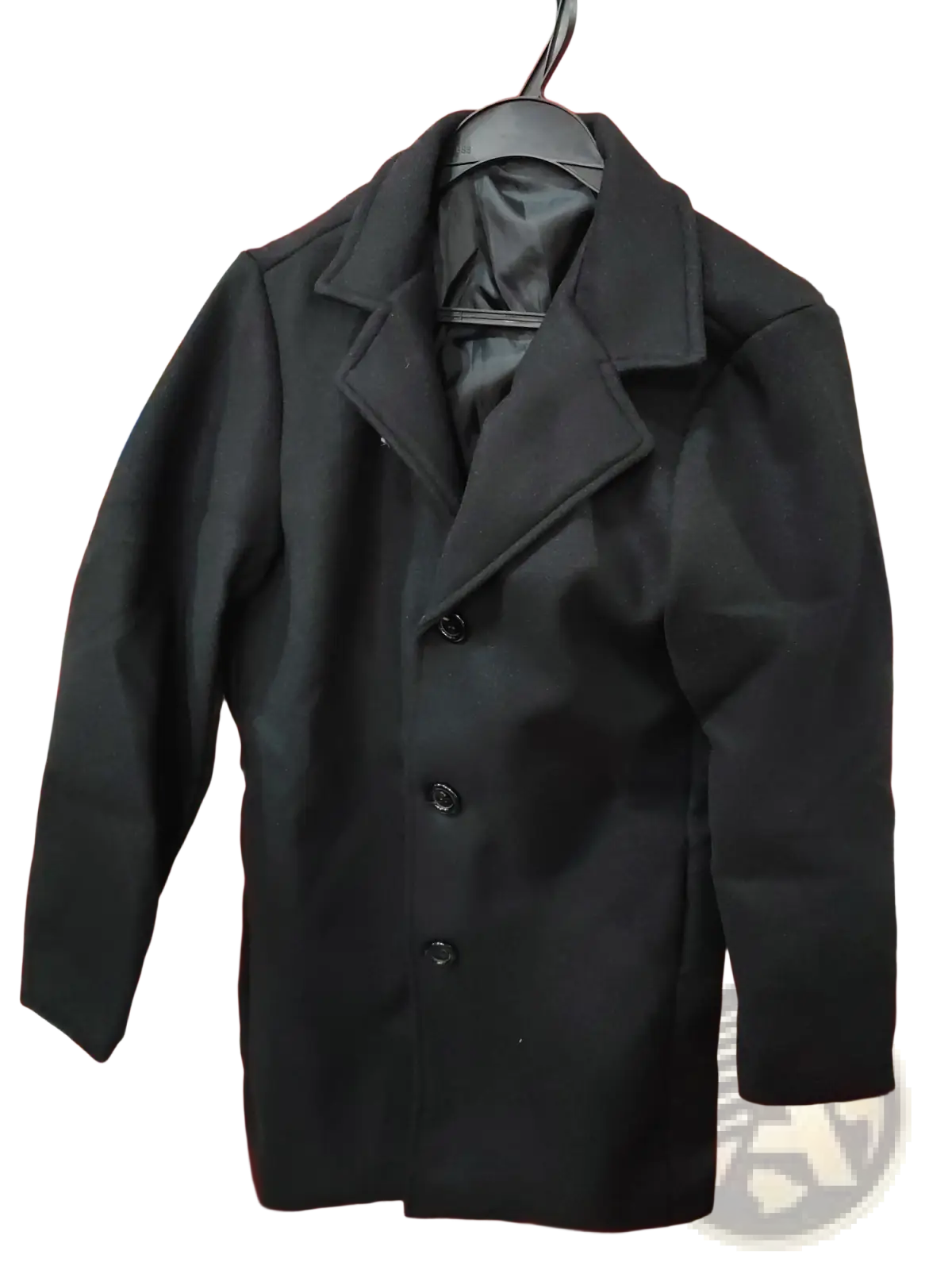 Black woolen double-breasted trench coat with classic collar and matching buttons hanging on a hanger for men