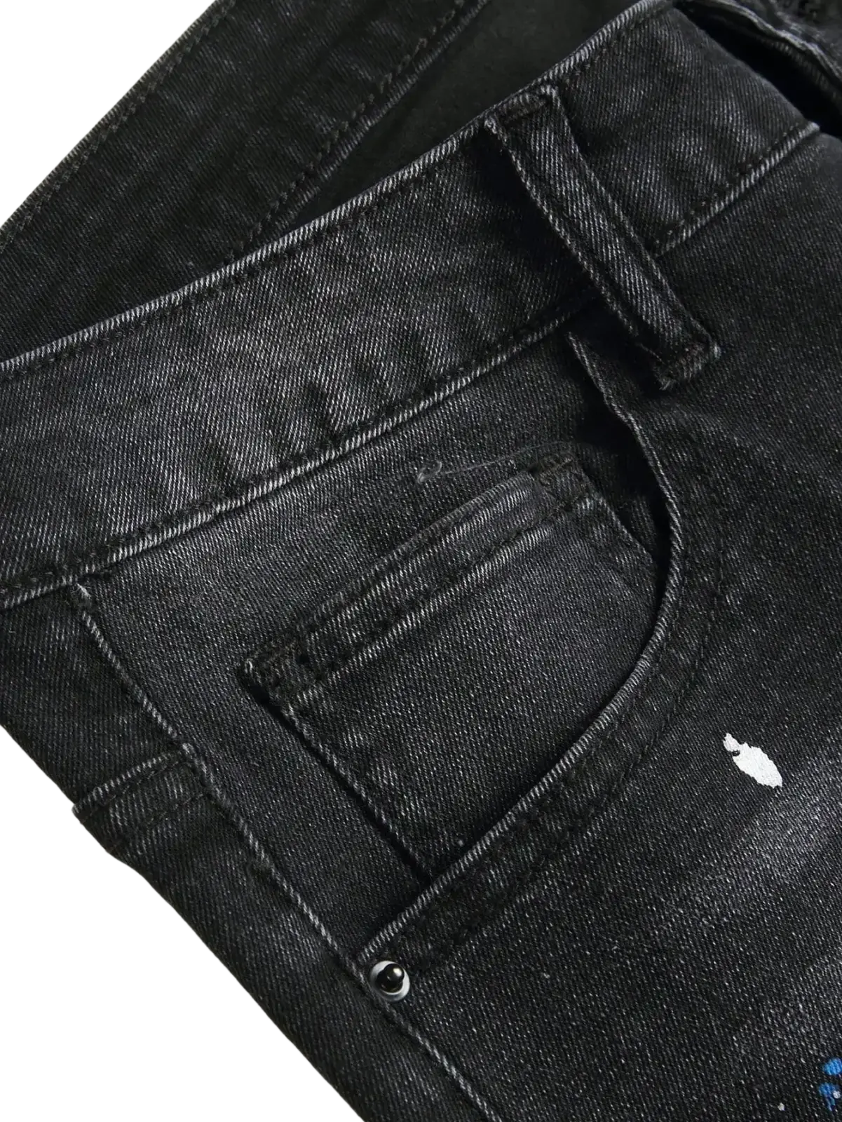 Men y2k stretchy skinny ripped denim jeans in black with distressed faded look and subtle white paint splatter details