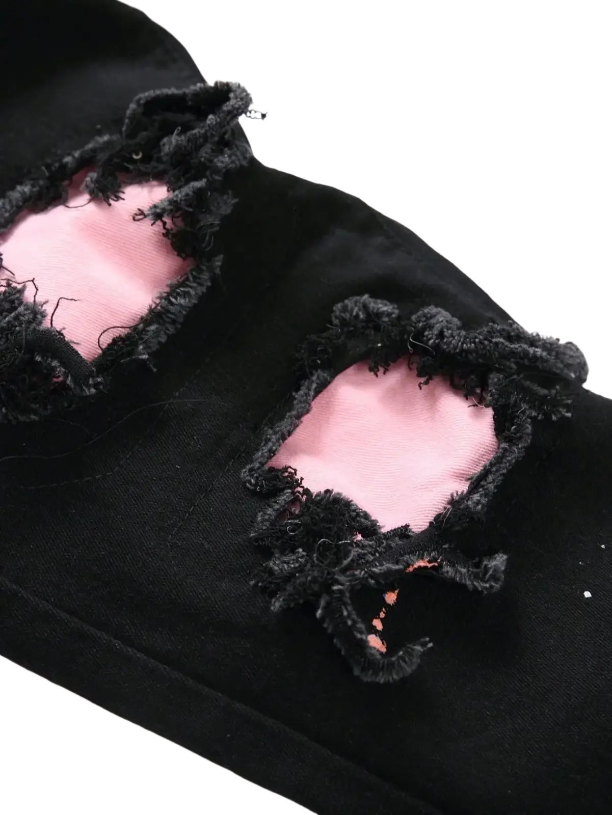 Men Y2k stretchy skinny ripped black denim jeans with distressed frayed patches and contrasting pink inner lining