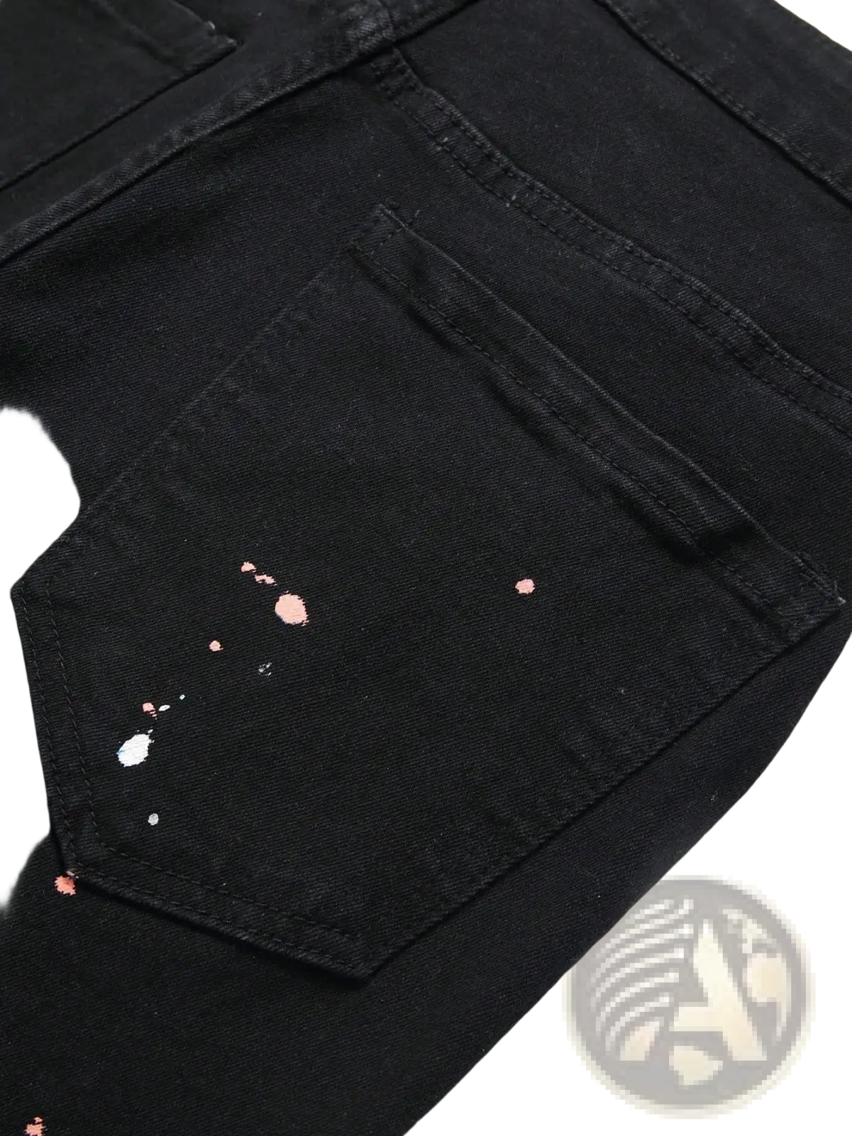Men y2k stretchy skinny ripped denim jeans in black featuring a distressed pocket with pink and white paint splatter accents