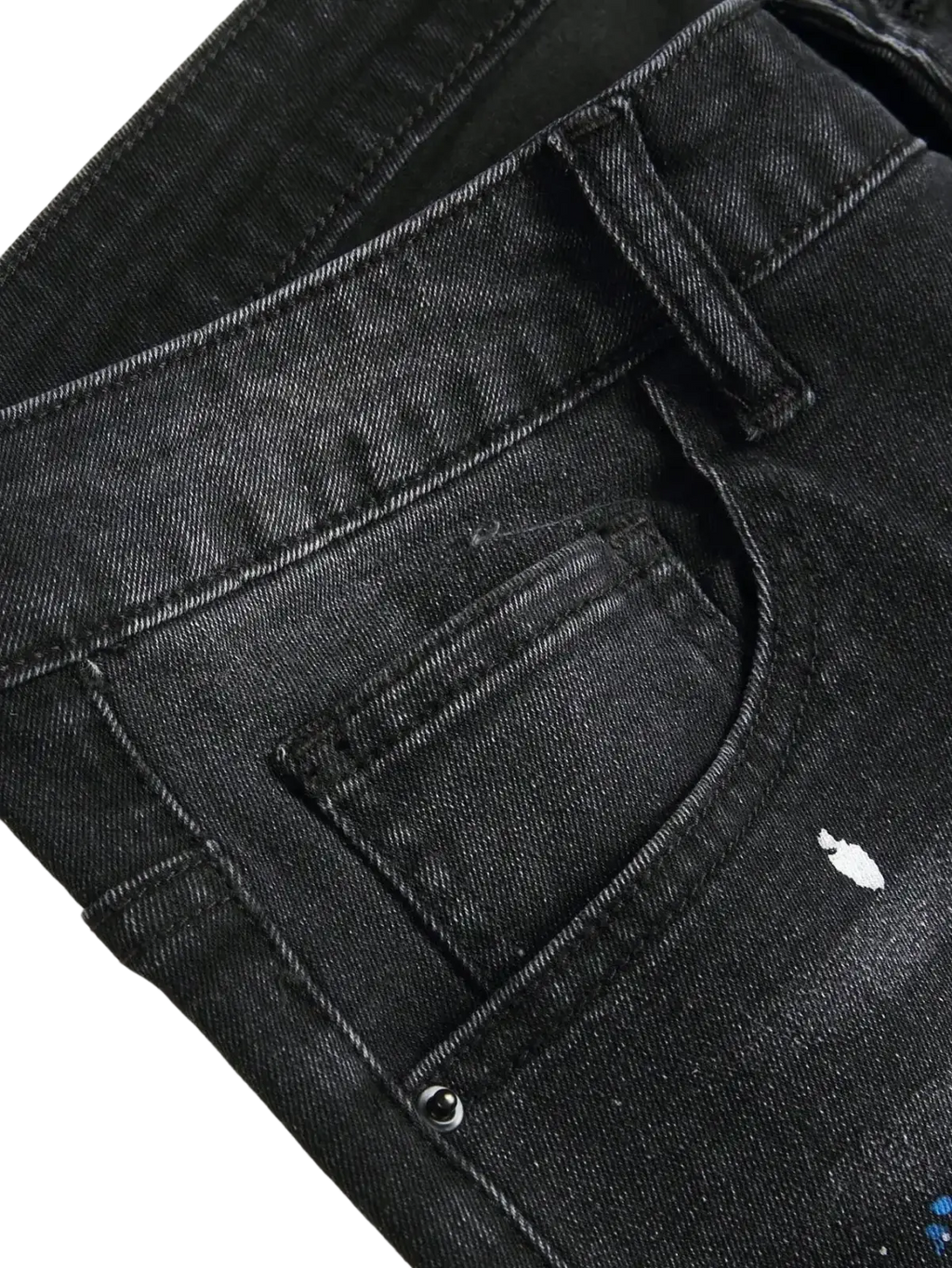 Men Y2k stretchy skinny ripped black denim jeans with distressed design and white and blue spray-painted accents