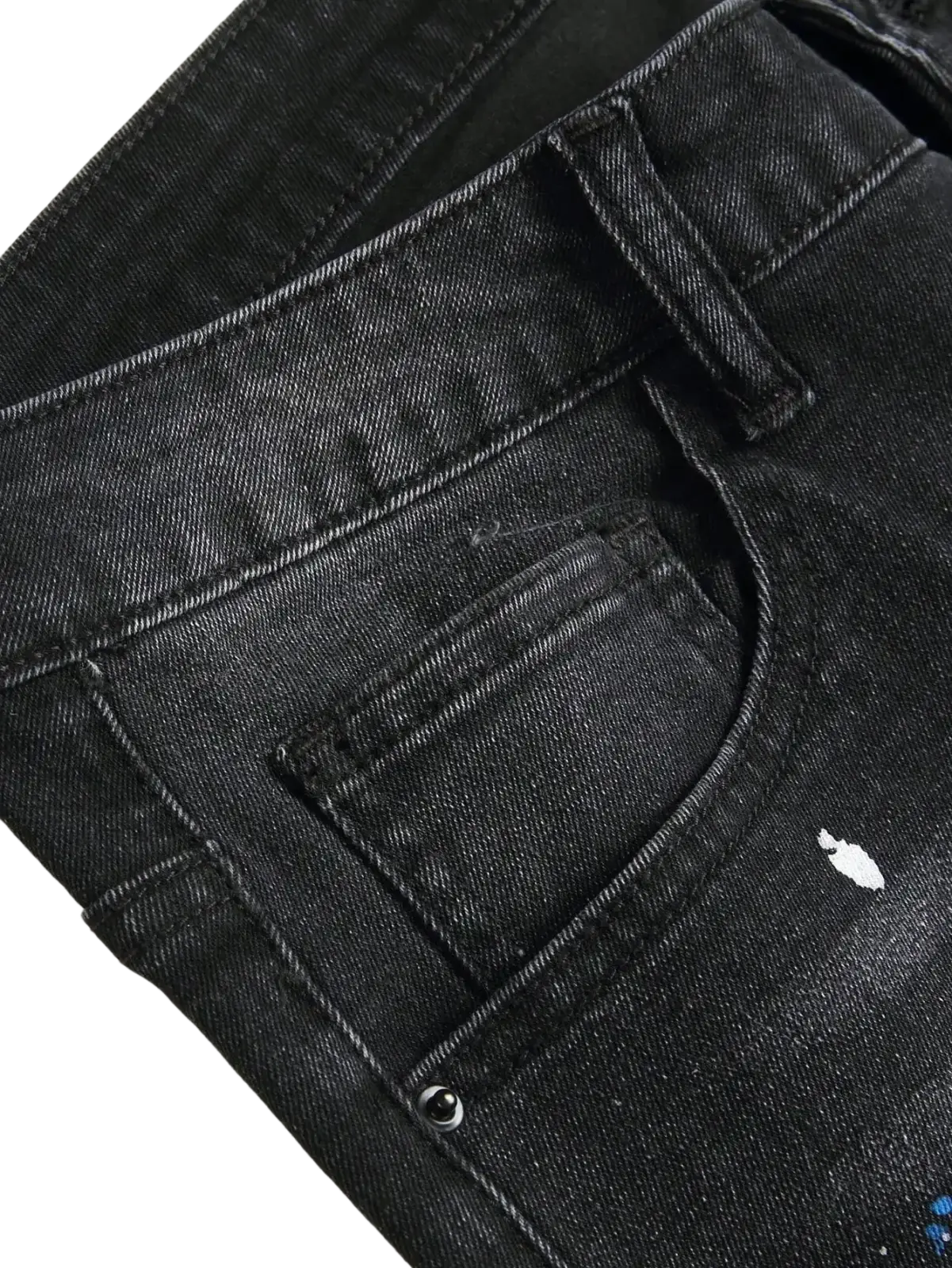 Men Y2k stretchy skinny ripped black denim jeans with distressed design and white and blue spray-painted accents