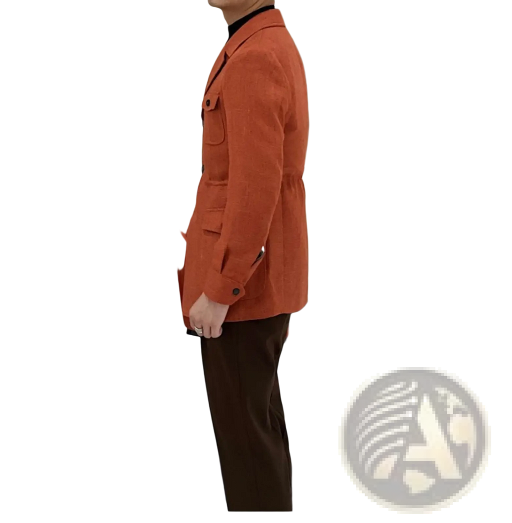 A man wearing a men’s belted slim fit blazer jacket in rust-orange wool with black trim and buttoned flap pockets