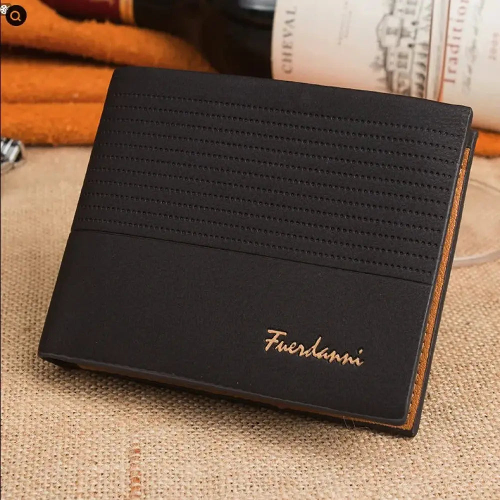 Black leather bifold card wallet with textured perforated pattern and gold fuerdanni branding on the front