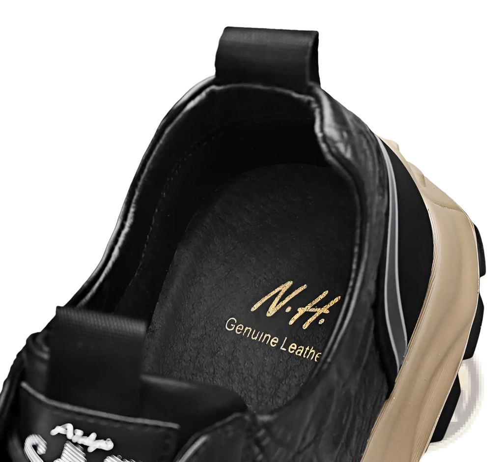 Men’s black crocodile embossed leather sneaker with tan rubber sole and gold n.h lettering on the insole