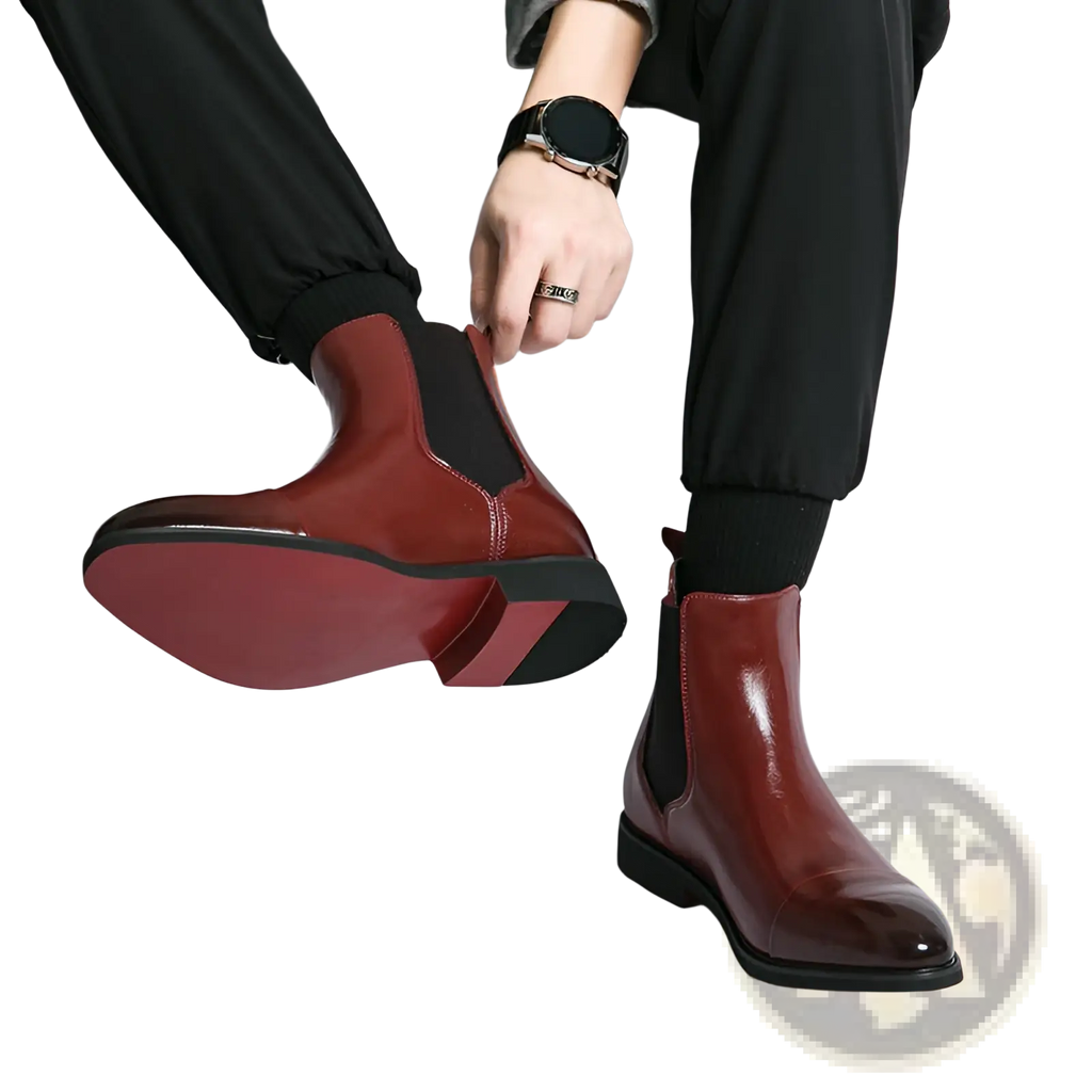 Men’s burgundy leather chelsea boots with black rubber soles and elastic side panels for sleek formal wear
