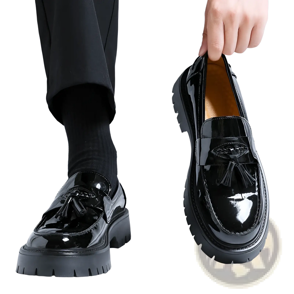 Men’s black patent leather tassel loafers with chunky rubber platform sole shown from the back side