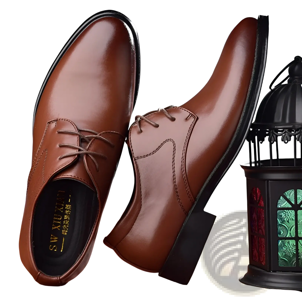 Men’s black pointed toe leather Oxford dress shoes in brown leather with black soles and laces visible from the front