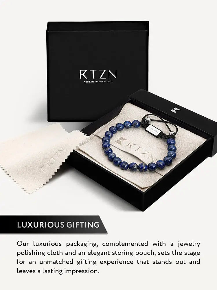 Men’s blue lapis lazuli beaded bracelet with polished deep blue stones, black cord, and silver-toned clasp